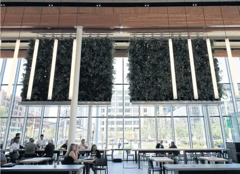  ?? AP ?? People sit at McDonald’s Corp’s new flagship restaurant in Chicago on Wednesday.