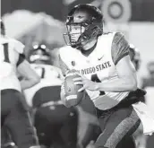  ?? GEORGE FREY AP ?? San Diego State quarterbac­k Jordon Brookshire looks for a receiver during the first half Saturday.