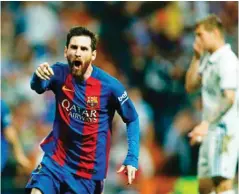  ?? — AFP ?? Messi celebrates Barcelona’s third goal yesterday.