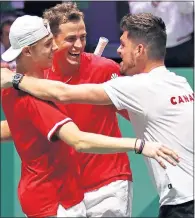  ??  ?? Denis Shapovalov and Vasek Pospisil celebrate victory with Canada team captain Frank Dancevic