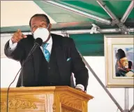  ?? Dan Haar / Hearst Connecticu­t Media ?? Members of the United House of Prayer for All People held their second week of in-person services in the church parking lot on Dixwell Avenue in New Haven on Sunday — the same time as a protest against the killing of George Floyd in Minneapoli­s. Above, the Rev. Stanley Woodley at the podium.