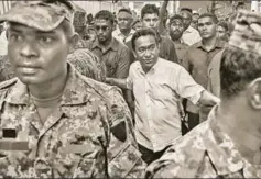  ?? AP ?? Maldivian president Yameen Abdul Gayoom with his bodyguards, Male, February 3