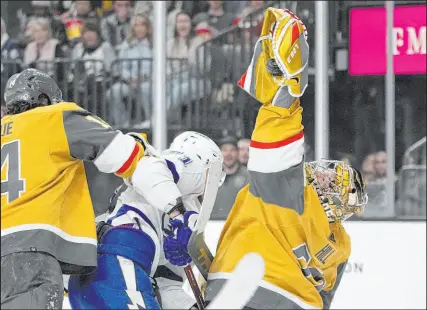  ?? ?? Adin Hill snags the puck en route to a 20-save night that helped the Knights pass a big test against the team that’s won the last three Eastern Conference crowns and the 2020 and 2021 Stanley Cups.