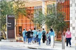  ?? Robin Jerstad / Contributo­r ?? People arrive for a Woman of Joy conference at the Convention Center, the first such event since the pandemic began.