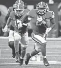  ?? JOHN DAVID MERCER/USA TODAY SPORTS ?? Georgia running back Kendall Milton carries against LSU during the SEC championsh­ip game Saturday in Atlanta. The top-ranked Bulldogs will face the Buckeyes on Dec. 31 in the College Football Playoff.