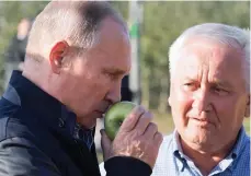  ??  ?? Crunch talks: Putin visits an orchard yesterday