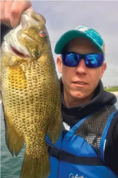  ?? | FOR THE SUN- TIMES ?? Matt Bach of Wheeling caught and released what is likely the Illinois- record rock bass with all kinds of documentat­ion.