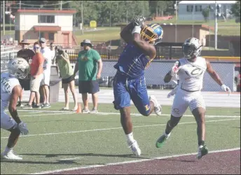  ?? The Sentinel-Record/Richard Rasmussen ?? REELING IT IN: Lakeside senior receiver J.J. Harvell, center, hauls in a touchdown pass from junior quarterbac­k Will Perrigo against a pair of Calvary Baptist Academy (Shreveport, La.) defenders Friday during pool play action at the 3rd Annual Live Like Bryce 7-on-7 Football Tournament at Lake Hamilton. The teams matched up again in the tournament finals with the Cavaliers beating the Rams, 16-14.