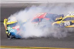  ?? DARRYL GRAHAM/ASSOCIATED PRESS ?? Eric Jones (77) collides with Kyle Busch, left, while Matt Kenseth (20) plows in from behind on lap 103. They were the first three cars out of the race.