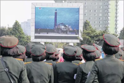  ?? AP PHOTO ?? People fill the square of the main railway station to watch a televised news broadcast of the test-fire of an inter-continenta­l ballistic rocket Hwasong-12 Wednesday in Pyongyang, North Korea.