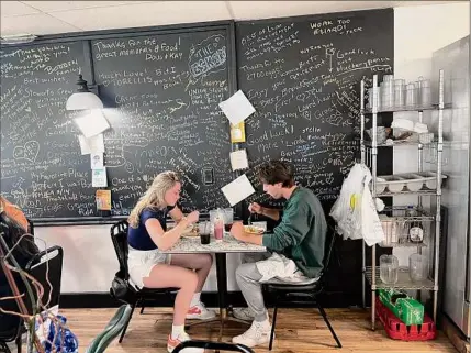  ?? Pete Demola / Times Union ?? A pair of diners eat breakfast on closing day for Oliver’s Cafe in Glenville on Sunday.