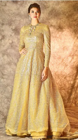  ??  ?? Matte gold long-sleeved gown with sequins.