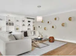  ?? (Design Recipes) ?? Broken “egg” ceramic art lined in gold makes a dramatic statement in this living room.