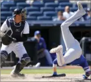  ?? KATHY WILLENS — THE ASSOCIATED PRESS ?? Toronto Blue Jays’ Ryan Goins flips after avoiding Dellin Betances’s eighth-inning pitch. Yankees catcher Austin Romine prepares to throw the ball back to Betances.