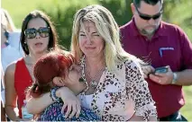  ?? PHOTO: AP ?? Parents wait for news after reports of the shooting at Marjory Stoneman Douglas High School.