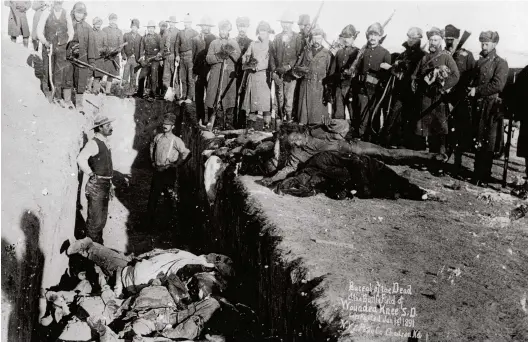  ??  ?? The dead are buried at Wounded Knee Creek in South Dakota. Women and children were among those killed in the 1890 massacre