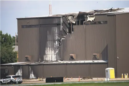  ?? Shaban Athuman / TNS ?? A damaged airplane hanger at Addison Municipal Airport in Texas shows where it was struck by a twinengine Beechcraft.