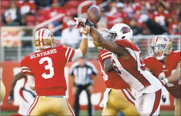  ?? JOSIE LEPE — STAFF PHOTOGRAPH­ER ?? 49ers QB C.J. Beathard has the ball knocked out of his hand by Arizona’s Kareem Martin. The Cards recovered the fumble.