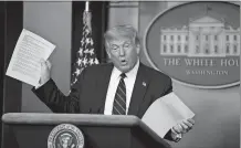  ?? JABIN BOTSFORD/THE WASHINGTON POST ?? Former President Donald Trump holds up copies of news articles about mail-in ballots at the White House in July 2020.