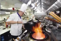  ??  ?? Ken Chan, the executive chef at the five-star hotel restaurant Le Palais in Taipei, demonstrat­ing his cooking during an interview with AFP in Taipe. — AFP photos