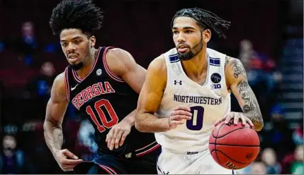  ?? Frank Franklin II / Associated Press ?? Boo Buie, right, drives past Georgia’s Aaron Cook during the second half of Northweste­rn’s 78-62 victory in the Roman Legends Classic on Tuesday. Buie went to Troy High before graduating from Maine’s Gould Academy.