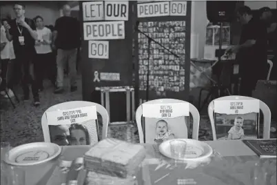  ?? MAYA ALLERUZZO FILE, AP PHOTO ?? Chairs for the Bibas family, hostages held in Gaza, are seen at a Passover seder table set Thursday at the communal dining hall at Kibbutz Nir Oz in southern Israel, where a quarter of all residents were killed or captured by Hamas on Oct. 7, 2023. Passover is a major Jewish holiday, celebrated over seven or eight days each year.