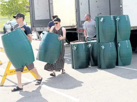  ?? GRANT LAFLECHE/STANDARD STAFF ?? The annual St. Catharines rain barrel sale and tree giveaway attracted hundreds of residents Saturday morning. Most of the barrels and trees were gone within an hour.