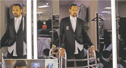  ??  ?? ABOVE: Jamie Nieto gets his tuxedo fitted for his July wedding. On good days, Nieto can shuffle 130 steps without a cane or walker. LEFT: Nieto, right, and his fiancée Shevon Stoddart, a Jamaican hurdler, check out wedding rings.