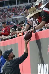  ?? Jason Behnken The Associated Press ?? A Tampa Bay Buccaneers fan gives quarterbac­k Tom Brady’s 600th career touchdown pass back after wide receiver Mike Evans threw the ball to the fan Sunday in Tampa, Fla.