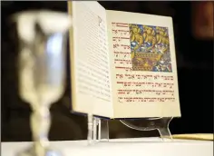  ?? (File Photo) ?? A Haggadah, a Jewish text that sets forth the order of the Passover Seder, is displayed inside the Lost Bridge Community Center in Garfield. With covid-19 restrictio­ns lifting, it will be easier for families and friends to gather and celebrate together.