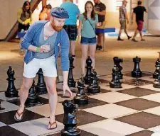  ??  ?? A guest plays chess in Big Game Theory during SMO 21 at Science Museum Oklahoma’s adults-only night.