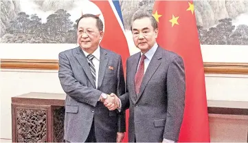  ??  ?? Ri meets Wang at the Diaoyutai State Guesthouse in Beijing. — Reuters photo