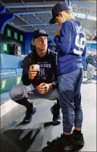  ?? Vaughn Ridley / Getty Images ?? Aaron Judge of the Yankees meets with Derek Rodriguez, 9, prior to a game Wednesday vs. the Blue Jays.