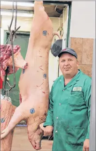  ?? CAROLE MORRIS-UNDERHILL ?? Meat cutter Greg Cummins displays a full pig carcass that’s ready to be cut up. He says it’s important for people to realize where the products they eat come from.