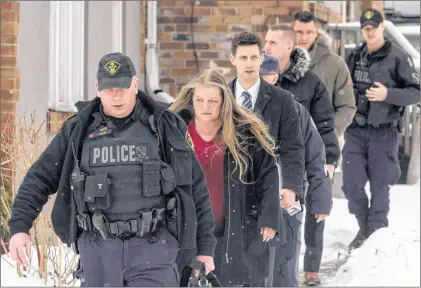  ?? CP PHOTO ?? Forensic Anthropolo­gist Professor Kathy Gruspier (second left) is seen Thursday with police officers at a Toronto property where alleged serial killer Bruce Mcarthur worked.