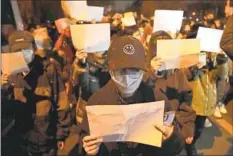  ?? Ng Han Guan Associated Press ?? PROTESTERS angry with harsh COVID-19 rules and other Chinese government restrictio­ns march in Beijing on Nov. 27.
