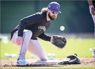  ?? PHOTOS BY AARON ONTIVEROZ — THE DENVER POST ?? Brendan Rodgers (7) of the Colorado Rockies works a short hop drill at second base during Spring Training at Salt River Fields in Scottsdale, Arizona on Wednesday, Feb. 21, 2024.