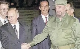  ??  ?? President Vladimir Putin (left) with Cuban leader Fidel Castro (right) during a welcoming ceremony on the arrival of Putin in Cuba for talks on this day in history in the year 2000.