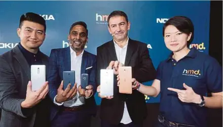  ?? PIC BY ROHANIS SHUKRI ?? HMD Global country manager (Malaysia and Myanmar) Vijay Thangavelu (second from left) and its vice-president for Asia Pacific James Rutherfoor­d (second from right) at the launch of the Nokia 6, Nokia 5, Nokia 3 and Nokia 3310 phones in Subang Jaya...