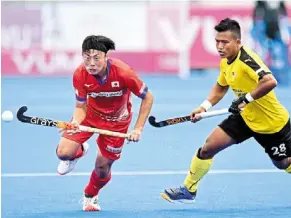  ?? ?? Relentless: malaysia’s Zulpidaus mizun (right) pressing Japan’s Taiki Takade during their Nations cup match. — Fih/world Sports Pic