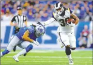  ?? The Associated Press ?? GURLEY MAN: Los Angeles running back Todd Gurley (30) avoids a tackle attempt from Lions defensive back Mike Ford Sunday during the first half of the Rams’ 30-16 victory in Detroit.