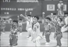  ?? TAO LIANG / XINHUA ?? Boys perform martial arts at the launch ceremony of a series of events marking this year’s National Fitness Day at the Olympic Center in Anshun, Guizhou province, on Aug 8.