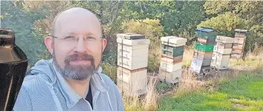  ?? ?? Buzzing Glen Heather Honey’s beekeeper, Chris Knight