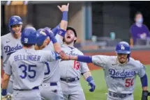  ?? AP PHOTO/ ERIC GAY ?? The Los Angeles Dodgers' Max Muncy (13) celebrates his grand slam during the first inning of Game 3 of the NL Championsh­ip Series against the Atlanta Braves on Wednesday in Arlington, Texas.