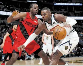  ?? AP/DAVID ZALUBOWSKI ?? Al-Farouq Aminu (8) of the Portland Trail Blazers defends against Paul Millsap of the Denver Nuggets during the Blazers’ victory in Game 2 of their NBA playoff series Wednesday night in Denver.