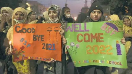  ?? K.M. CHAUDARY/AP ?? Students participat­e in a demonstrat­ion Friday to say goodbye to 2021 in Lahore, Pakistan.