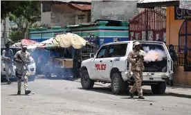  ?? Haiti. Photograph: Richard Pierrin/AFP/Getty Images ?? Police officers throw tear gas to demonstrat­ors during a protest against insecurity in Portau-Prince,