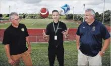  ?? CLIFFORD SKARSTEDT EXAMINER ?? Jack Veitch, manager of Community Engagement and Education for CMHA HKPR. juggles a football and rugby ball between Team 55 Let's Tackle Suicide Awareness founder Dave Pogue, left, and football coach Jeff Challice during a press conference Wednesday at TASSS.