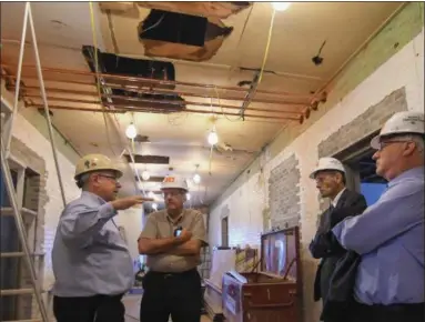  ?? ERIC BONZAR — THE MORNING JOURNAL ?? From left: Project architect Ron Cocco gives an update on the progress of the historical Lorain County Courthouse renovation project as Lorain County Historical Society Executive Director Bill Bird, and Lorain County Commission­ers Ted Kalo and Matt...