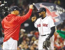  ?? Associated Press photo ?? Boston Red Sox manager Alex Cora, left, and center fielder Jackie Bradley Jr. celebrate after their win against the Houston Astros in Game 2 of a baseball American League Championsh­ip Series on Sunday in Boston.